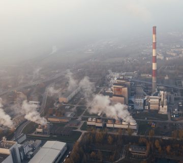 Toxic smoke pours out of industrial chimneys, polluting the air. The atmosphere has been steadily heating up to a dangerous temperature as a result of pollution like this.